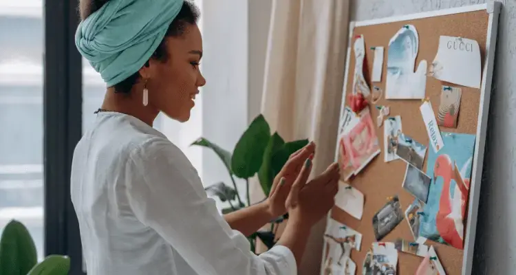 Picture of a lady visualizing her financial goals on a Vision Board